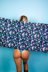 Woman showcasing Mushies Festival Scarf with colorful mushroom print against a blue background, perfect for rave outfits.