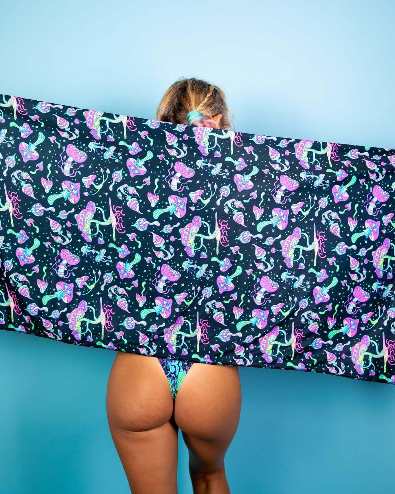 Woman showcasing Mushies Festival Scarf with colorful mushroom print against a blue background, perfect for rave outfits.