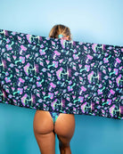 Woman showcasing Mushies Festival Scarf with colorful mushroom print against a blue background, perfect for rave outfits.