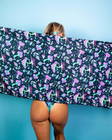 Woman showcasing Mushies Festival Scarf with colorful mushroom print against a blue background, perfect for rave outfits.