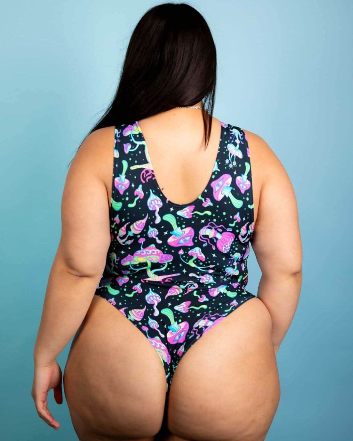 Back view of plus-size individual wearing a psychedelic mushroom bodysuit, perfect for rave outfits and festivals.