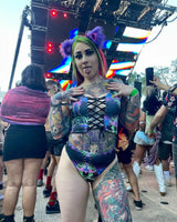 model wears a neon outfit in festival crowd and cat ears