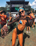 Model wearing Black Mesh Baelien rave arm sleeves at outdoor festival with arms raised celebrating