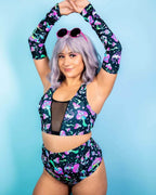 Model wearing colorful Mushies rave arm sleeves with psychedelic mushroom print in front pose for festival outfit styling