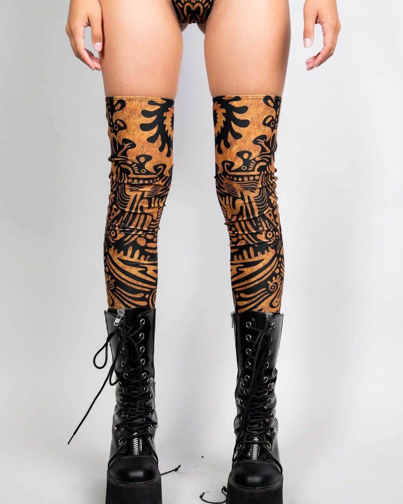 Rave arm sleeves styled as Primal leg sleeves in copper with black tribal patterns for festival outfit