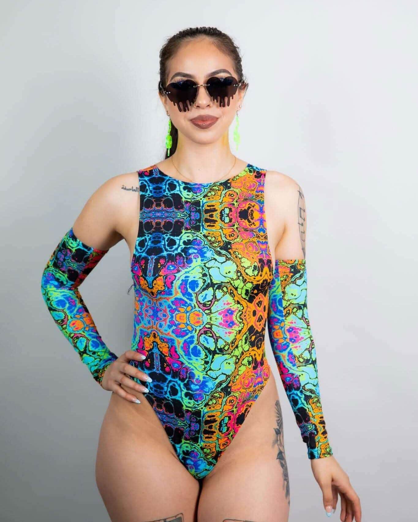 Woman modeling Lucidity psychedelic rainbow rave bodysuit with cutout sleeves front view festival outfit