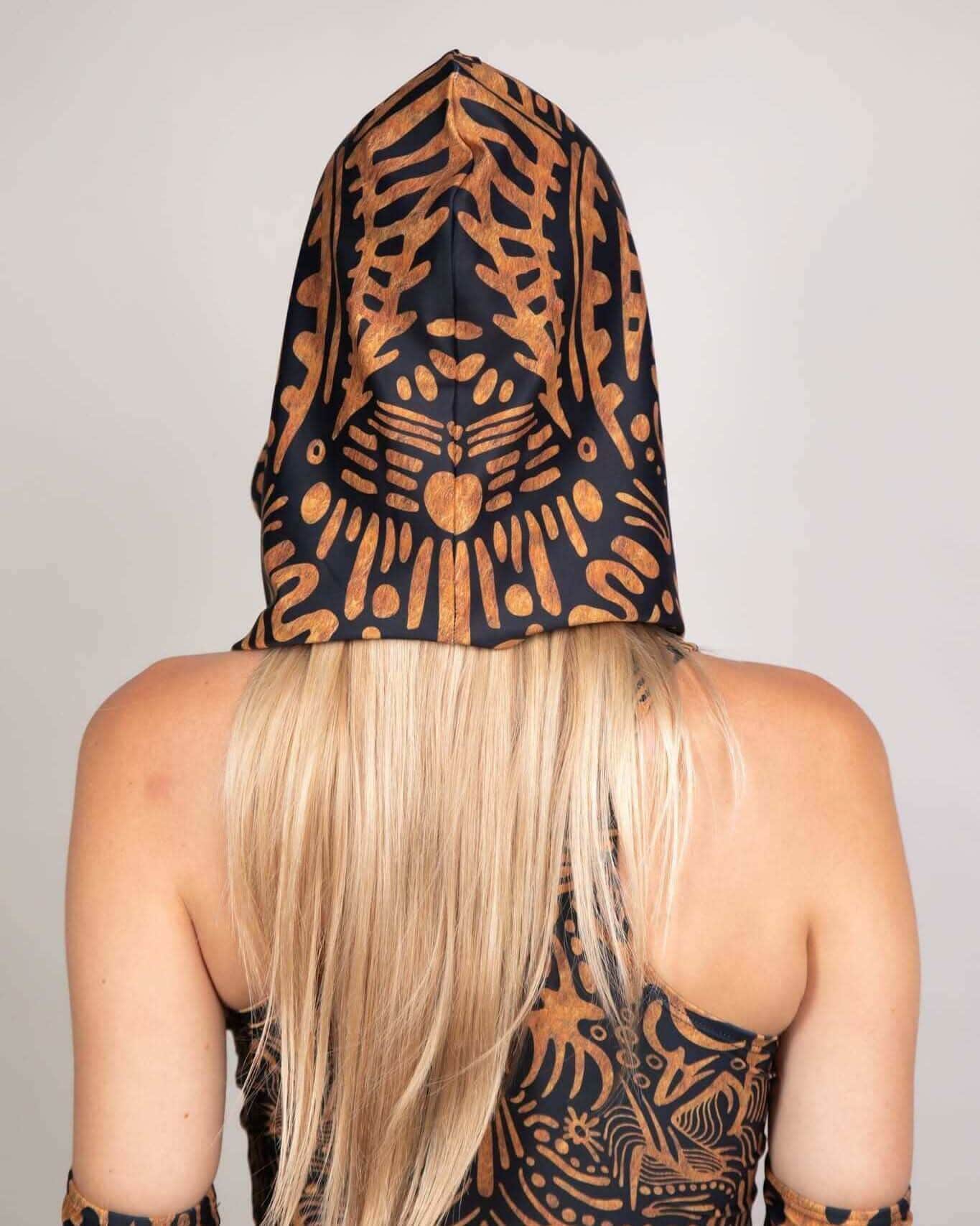 Rave bodysuit Primal Assassin Hood back view showing black orange tribal pattern festival wear
