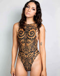 Model wearing tan Primal rave bodysuit with black geometric print and side cutouts for festival fashion