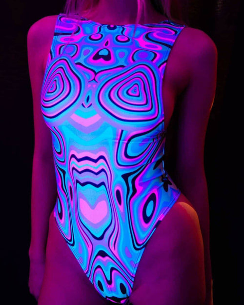 Sugar Rush rave bodysuit with psychedelic blue pink swirls glowing under blacklight UV lighting front view