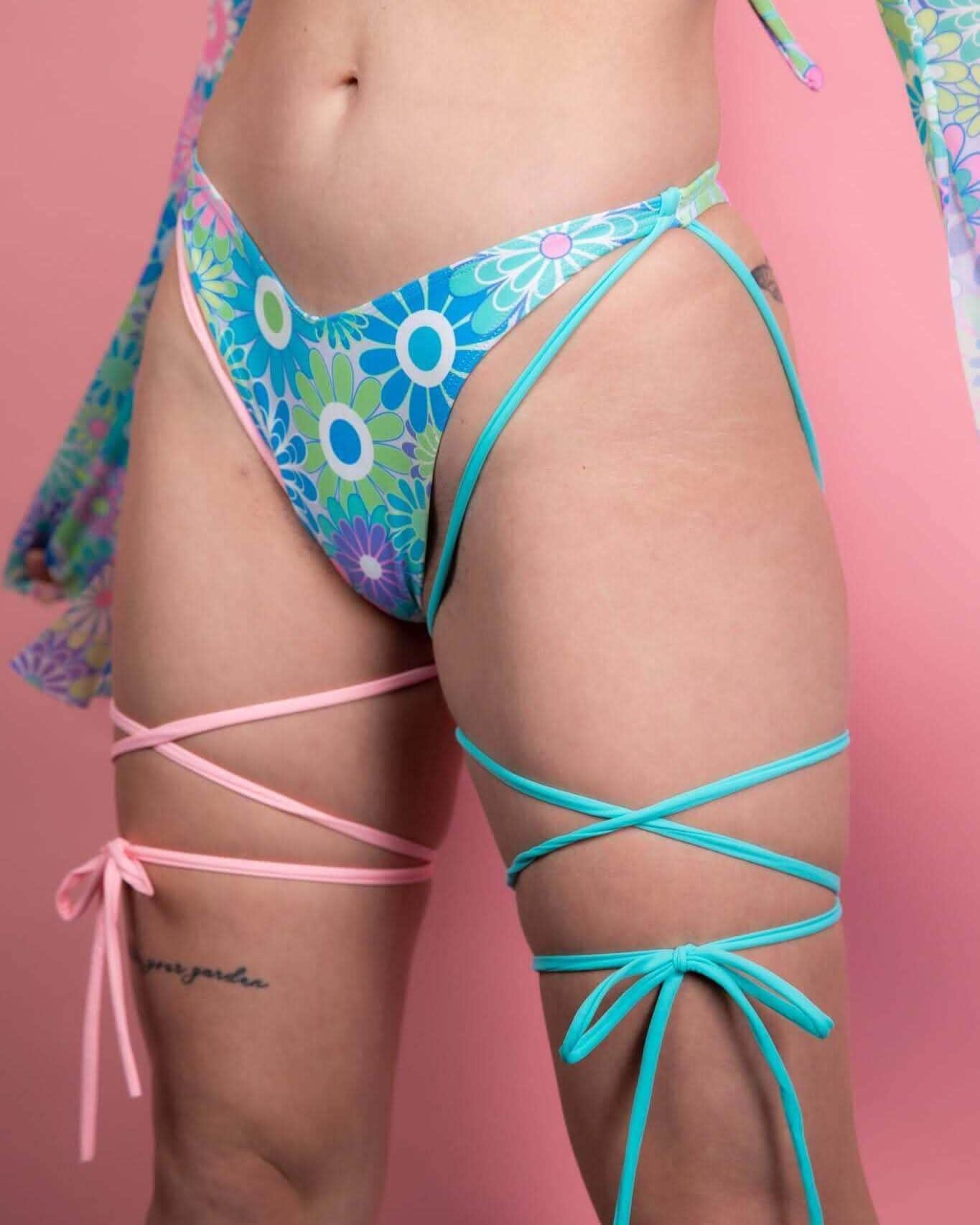 Retro Bloom floral rave pants with strappy leg ties festival outfit detail view