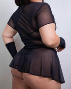 Black mesh swirl rave skirt styled from back view showing wrap design and sheer festival fashion details