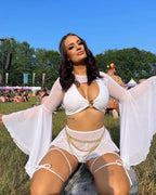White mesh swirl rave skirt styled at outdoor festival with flowing sleeves and chain accessories