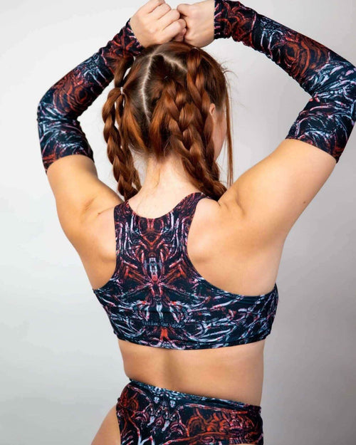 Back view of Darkness rave top with psychedelic print, model styling braided hair in matching festival outfit