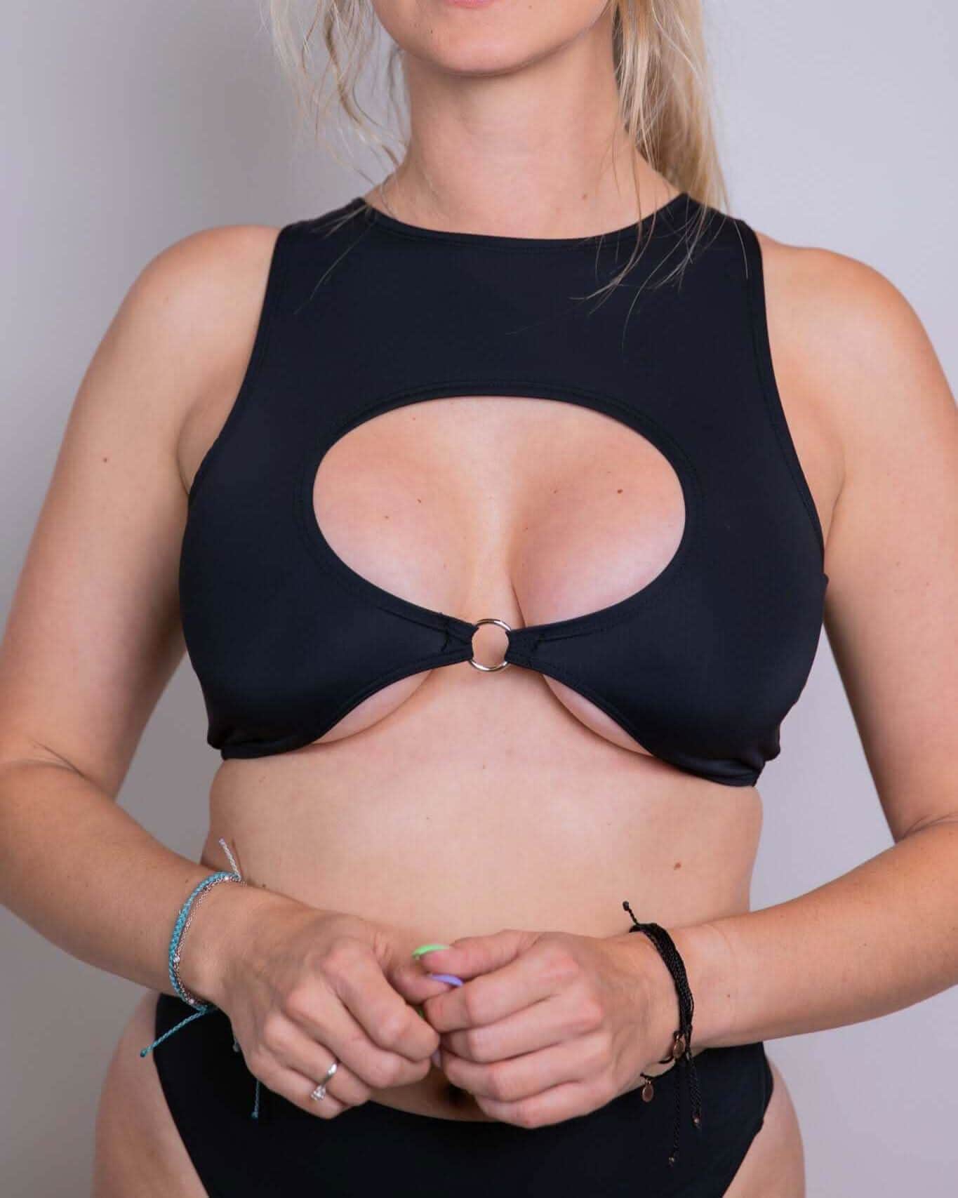 Matte black keyhole rave top with O-ring detail modeled from front showing strategic cutout design