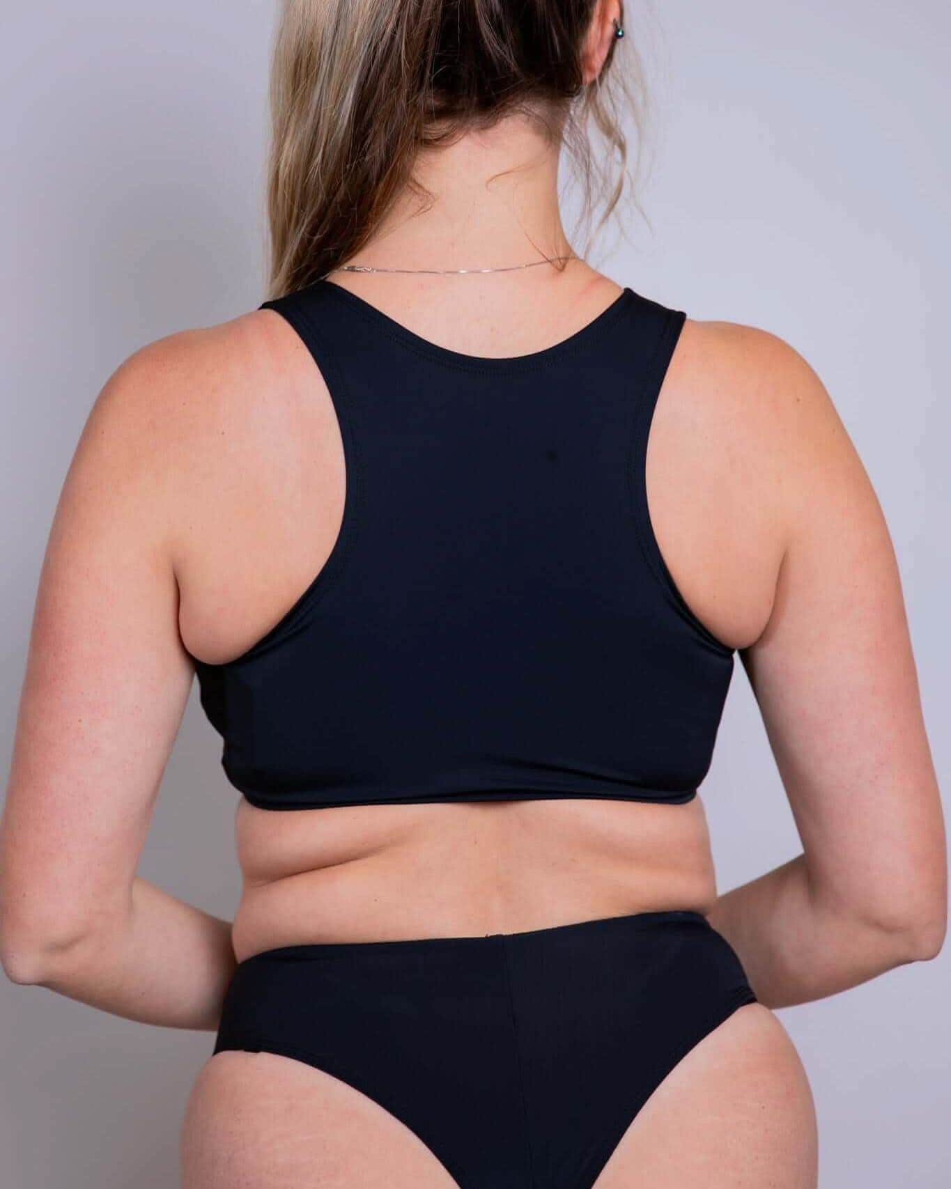 Back view of matte black keyhole rave top with racerback design and matching festival bottoms