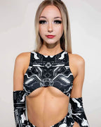 Black Mechanoid rave top with geometric print and underboob cutout modeled from front view