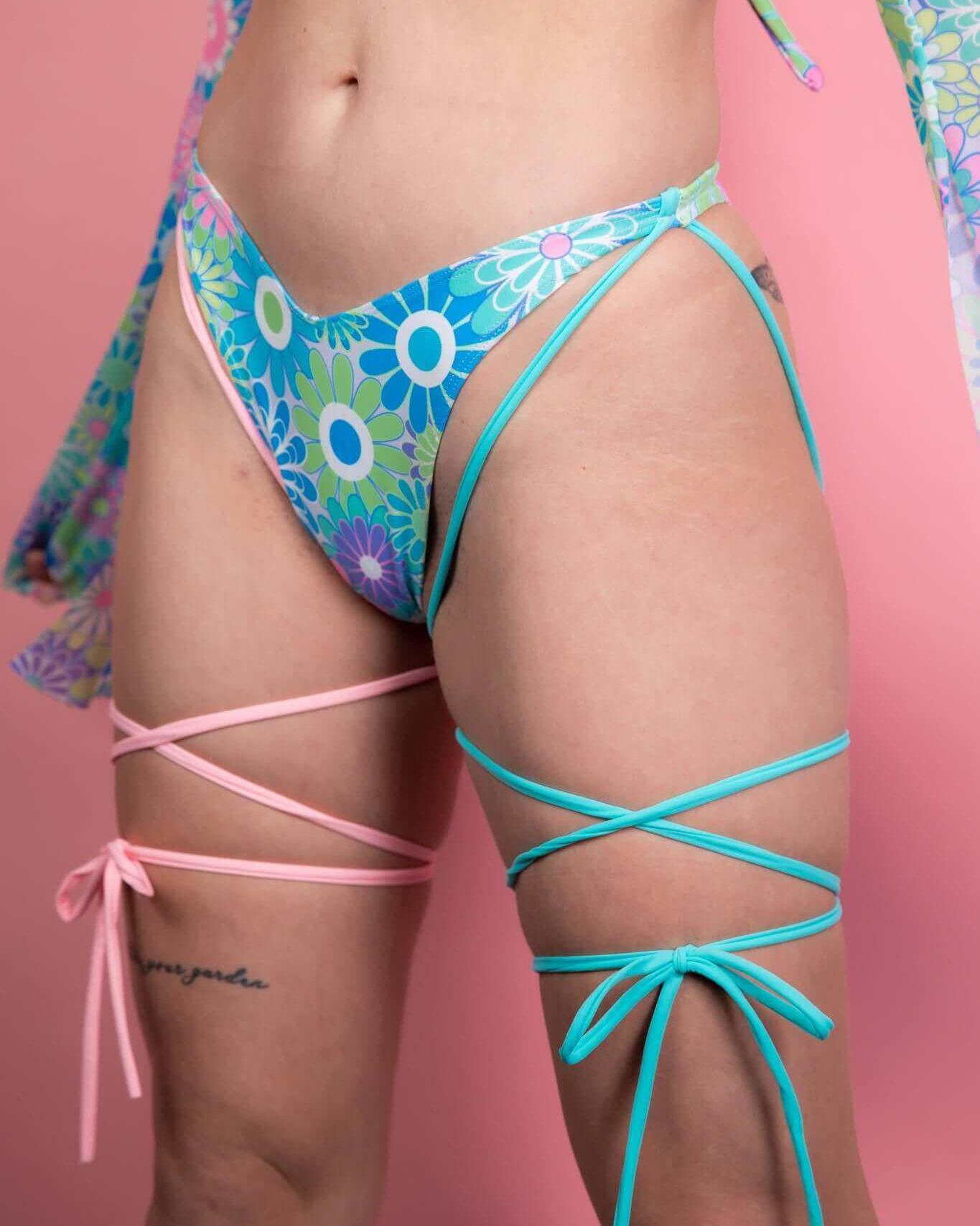 Retro Bloom strappy high hip bikini bottoms with vibrant floral print and colorful straps, perfect for rave outfits.