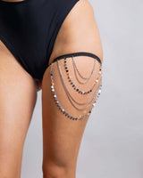 Silver chain leg garter accessory worn on thigh, perfect for stylish rave outfits and adding flair to any look.