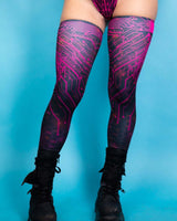 Pink Singularity leg sleeves featuring a circuit design, perfect for rave outfits and festival style.