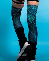 Teal leg sleeves with circuit pattern, perfect for rave outfits and festival fashion, featuring a soft and stretchy design.