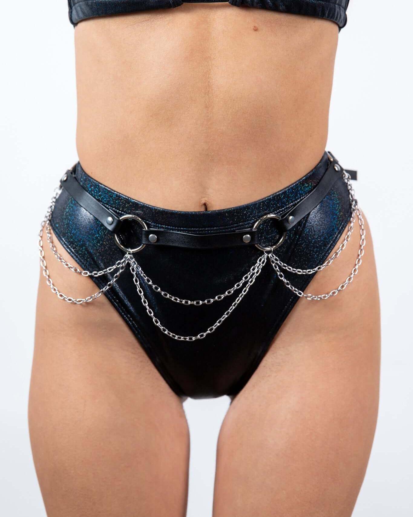 Model showcasing a stylish black high-waisted bikini bottom with silver chain detailing, perfect for rave outfits.