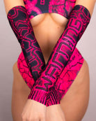 Pink Toxic arm sleeves adding style to rave outfits with a sleek and stretchy fit, handmade in San Diego.