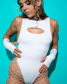 Model showcasing a stylish white eco-luxe bodysuit with cutout and fishnet tights, perfect for rave outfits.