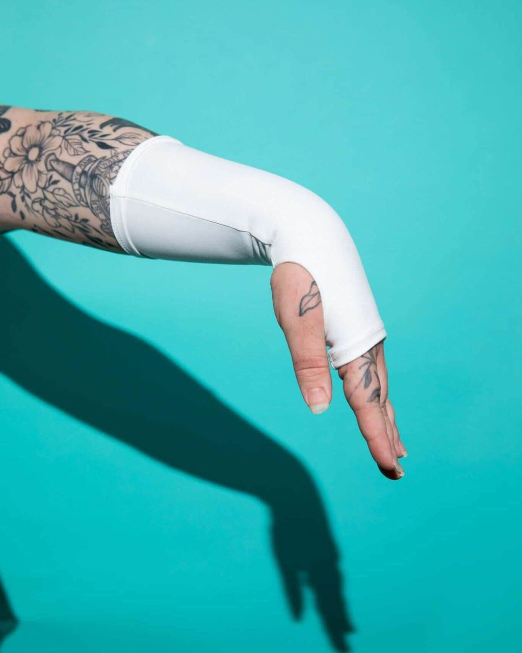 White Eco-Luxe gloves with thumb holes, styled for rave outfits, showcasing sustainable fashion.