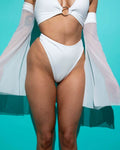 Model showcasing a white eco-luxe high waisted thong, perfect for rave outfits, with a soft and stretchy design.