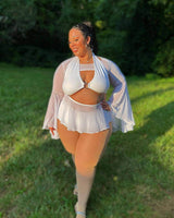 Model showcasing white mesh bell sleeves with a flowy skirt, perfect for rave outfits and stylish summer looks.