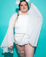 Model showcasing white mesh bell sleeves with dramatic flares, perfect for rave outfits against a vibrant turquoise backdrop.