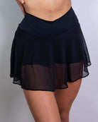 Women's matte black mesh skort with attached shorts, perfect for rave outfits, showcasing a stylish and slim fit.