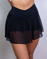 Women's matte black mesh skort with attached shorts, perfect for rave outfits, showcasing a stylish and slim fit.
