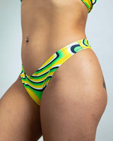 Close-up of vibrant yellow and green Wonky Brazilian bikini bottoms, perfect for stylish festival rave outfits.
